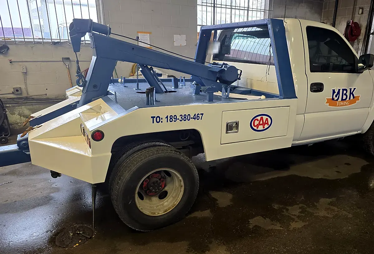 Freshly painted UBK Towing wheel-lift tow truck in the garage