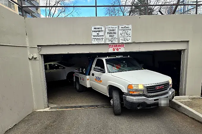 UBK tow truck backing into an underground garage with 5 foot 6 inch clearance
