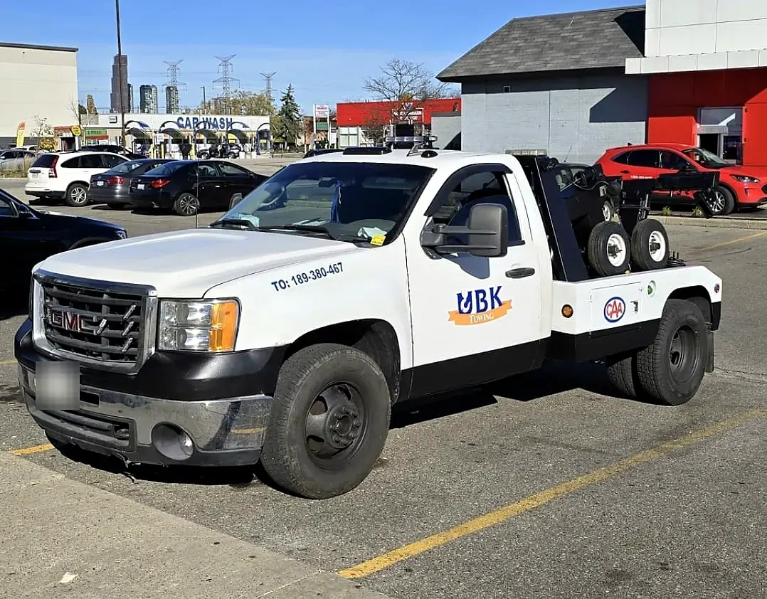 UBK Towing wheel-lift tow truck with CAA decal parked in Toronto